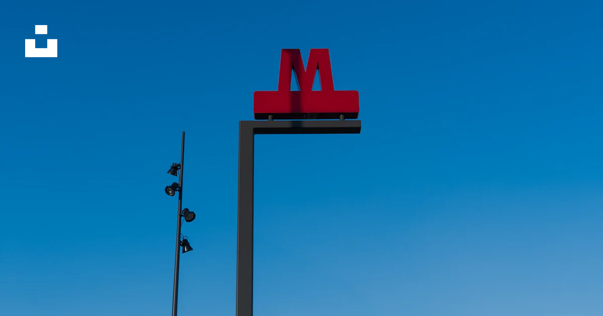 M Sign Horizontal A red m sign on top of a tall pole photo – Free Denmark Image on Unsplash