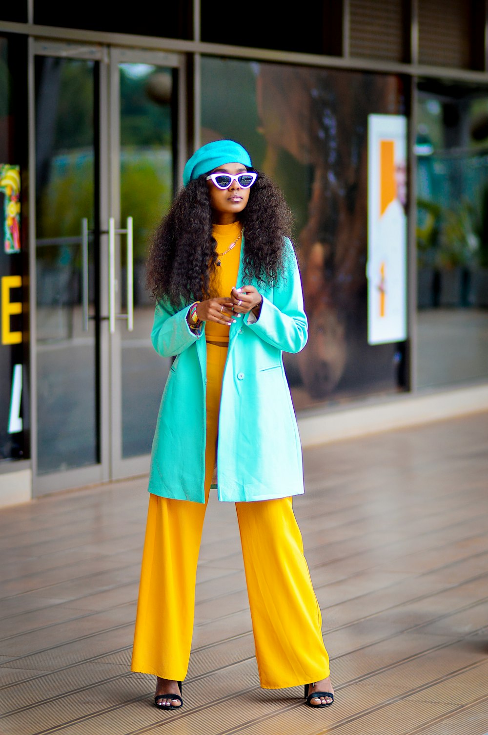 a woman in yellow pants and a blue coat