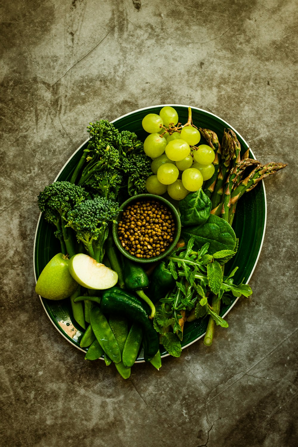 a plate of fruits and vegetables on a table