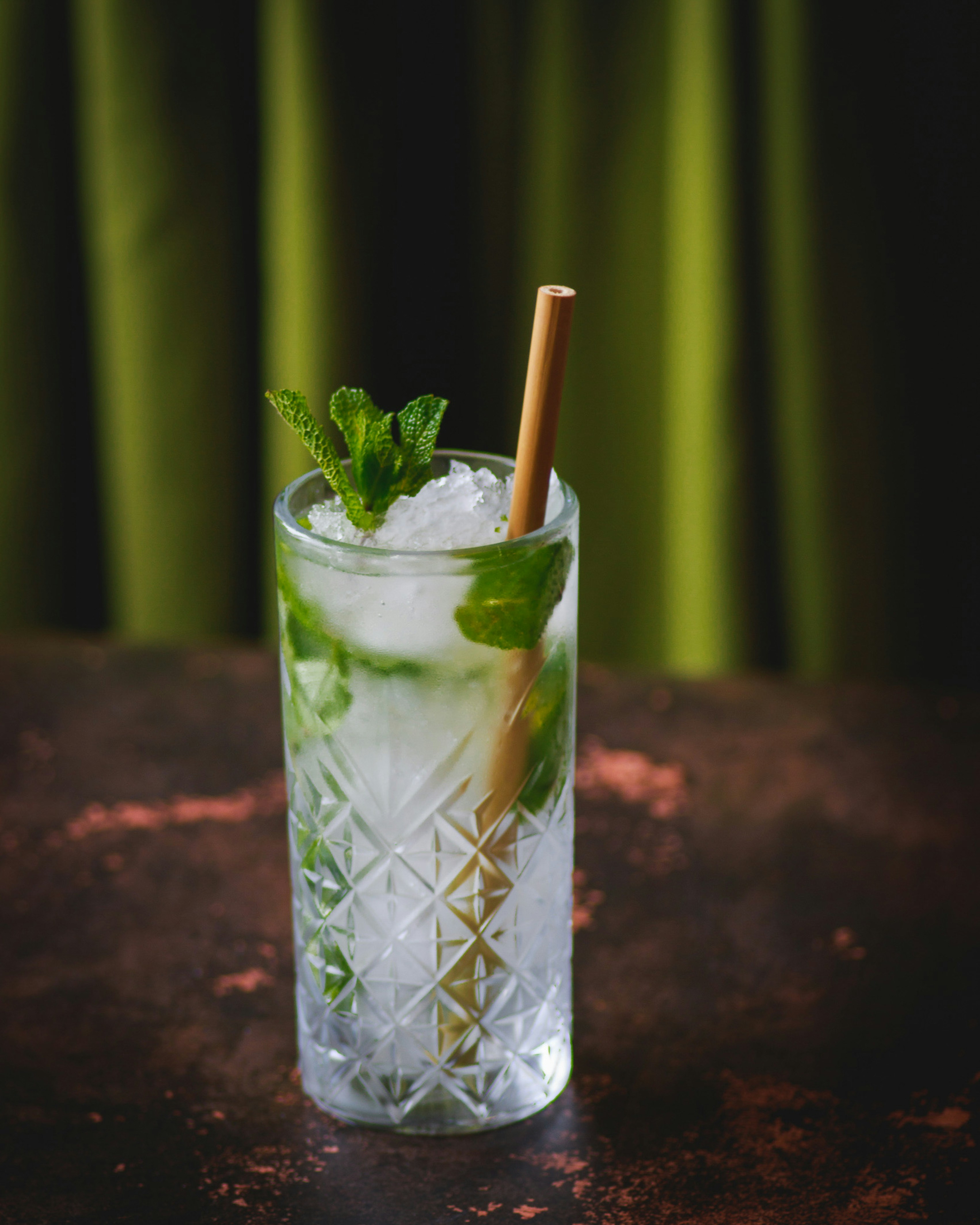a glass filled with ice and a straw