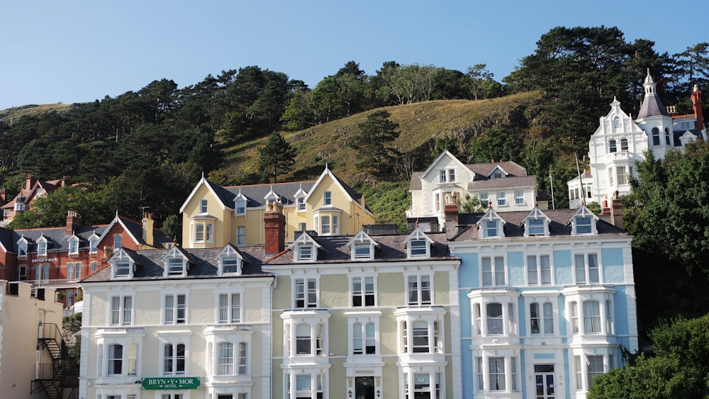 a row of multi - colored houses on a hillside