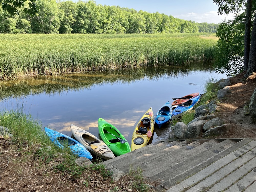 a group of kayaks sitting on top of a wooden dock