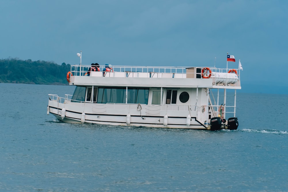 a large white boat floating on top of a large body of water