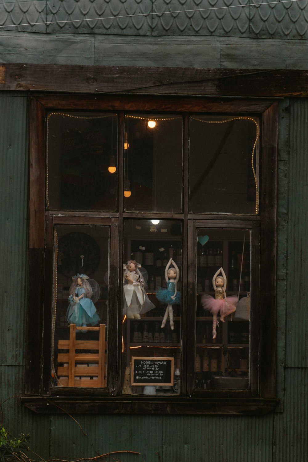 a window that has a bunch of dolls in it