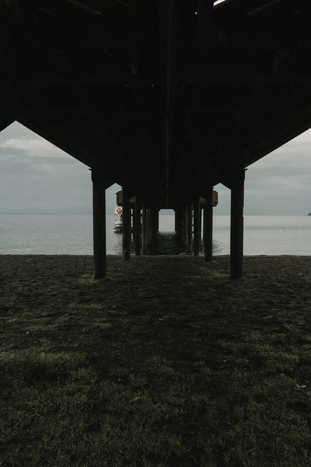 a view of the ocean from under a pier