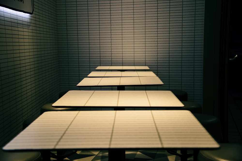 a long table with four stools in a room