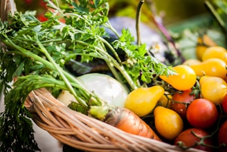 A vibrant basket overflowing with freshly picked fruits and vegetables, glowing under natural sunlight.