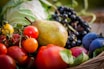 A close-up of fresh fruits and vegetables in a market basket.