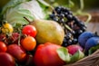 Close-up of colorful fruits and vegetables neatly arranged in a basket.
