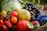 A variety of fresh fruits and vegetables including tomatoes, a pear, grapes, and plums are arranged in a basket. The scene is colorful and vibrant, with the focus on the natural textures and colors of the produce.