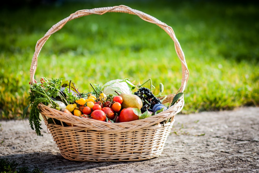 a wicker basket filled with assorted fruits and vegetables
