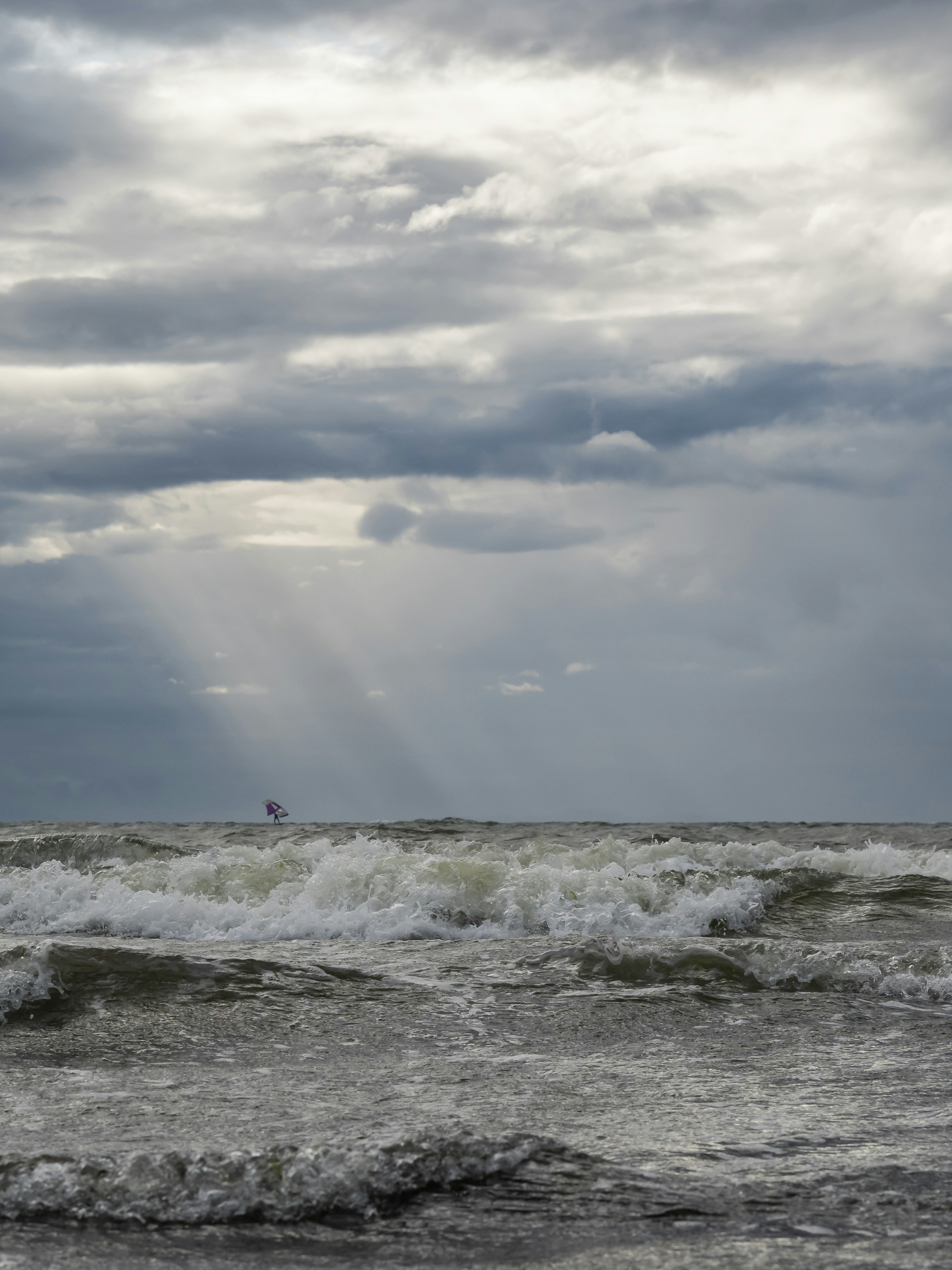 a person riding a surfboard on a wave in the ocean