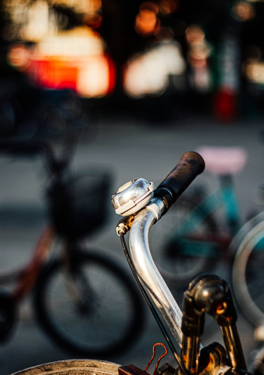 a close up of a bike handlebar with other bikes in the background