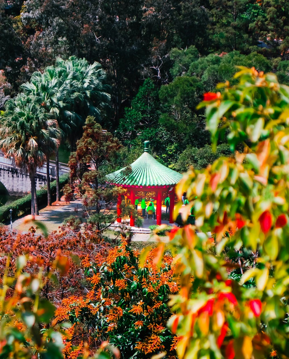 a gazebo in the middle of a park surrounded by trees