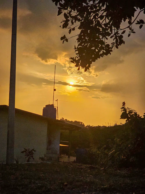 A warm sunset casting golden light over a sparkling clean home exterior.