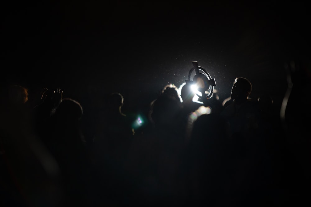 a crowd of people standing around a person on a bike