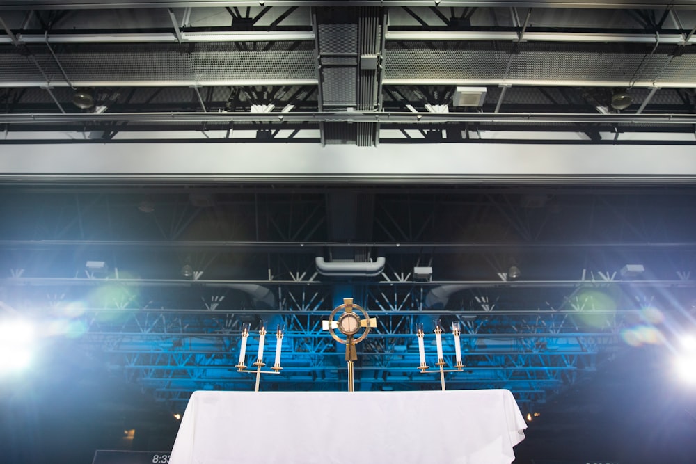 a cross on a table in front of a stage