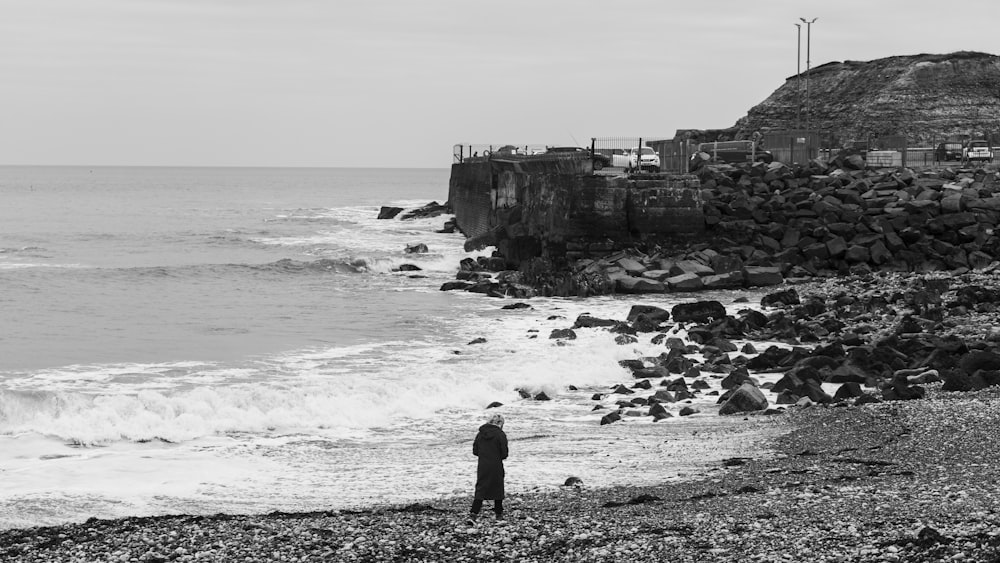 a person standing on a beach near the ocean