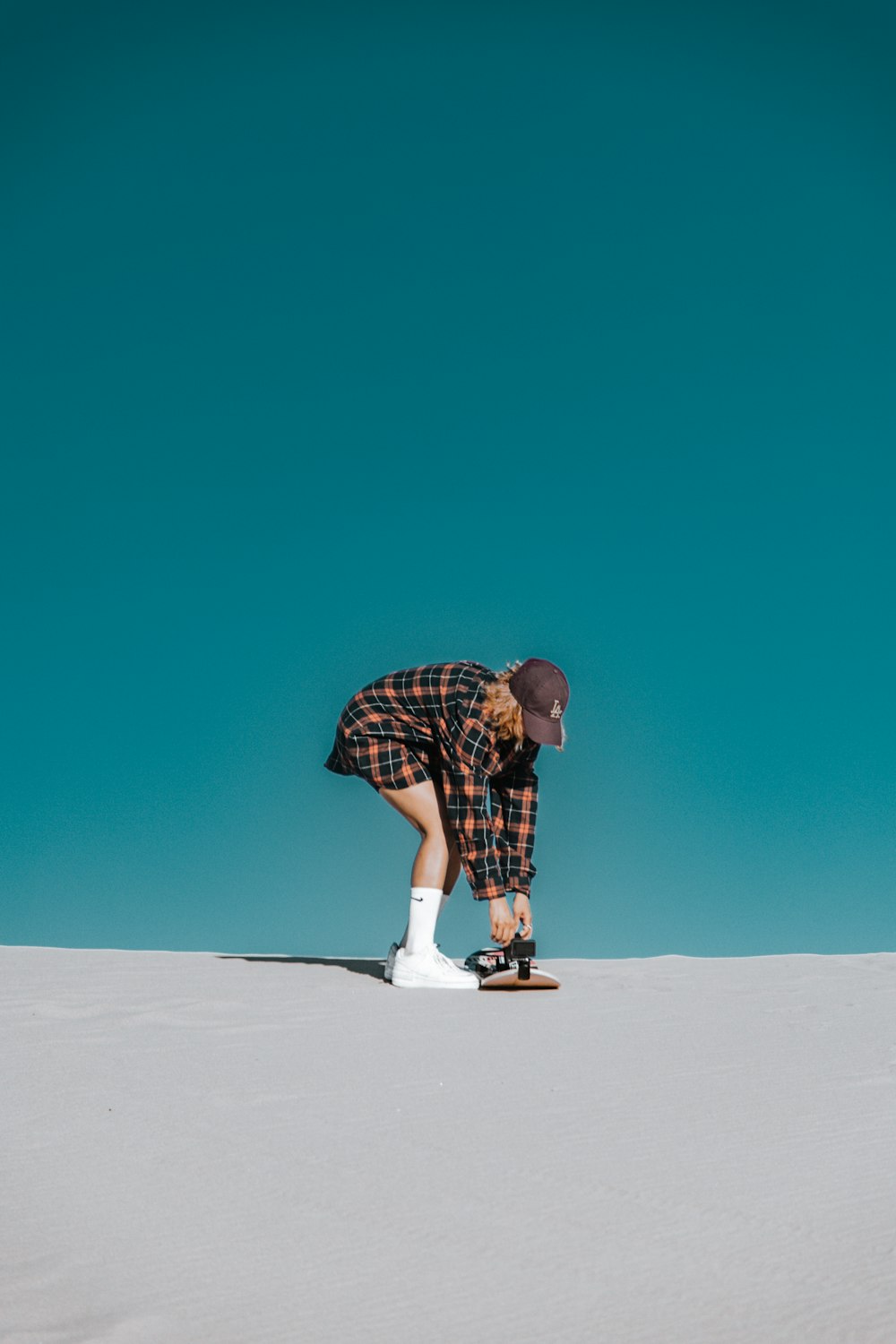 a man riding a snowboard down a snow covered slope