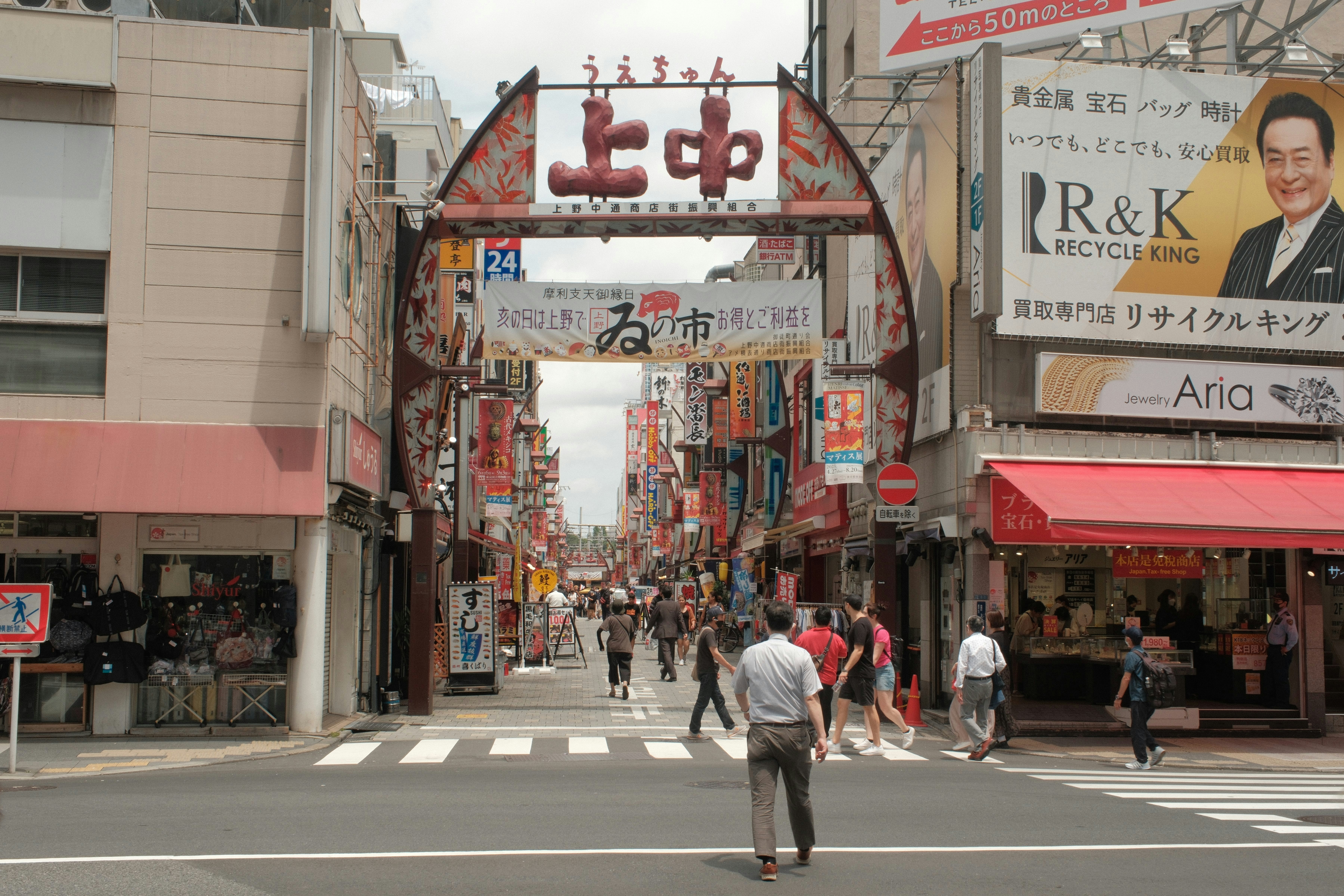 a busy city street with people crossing the street