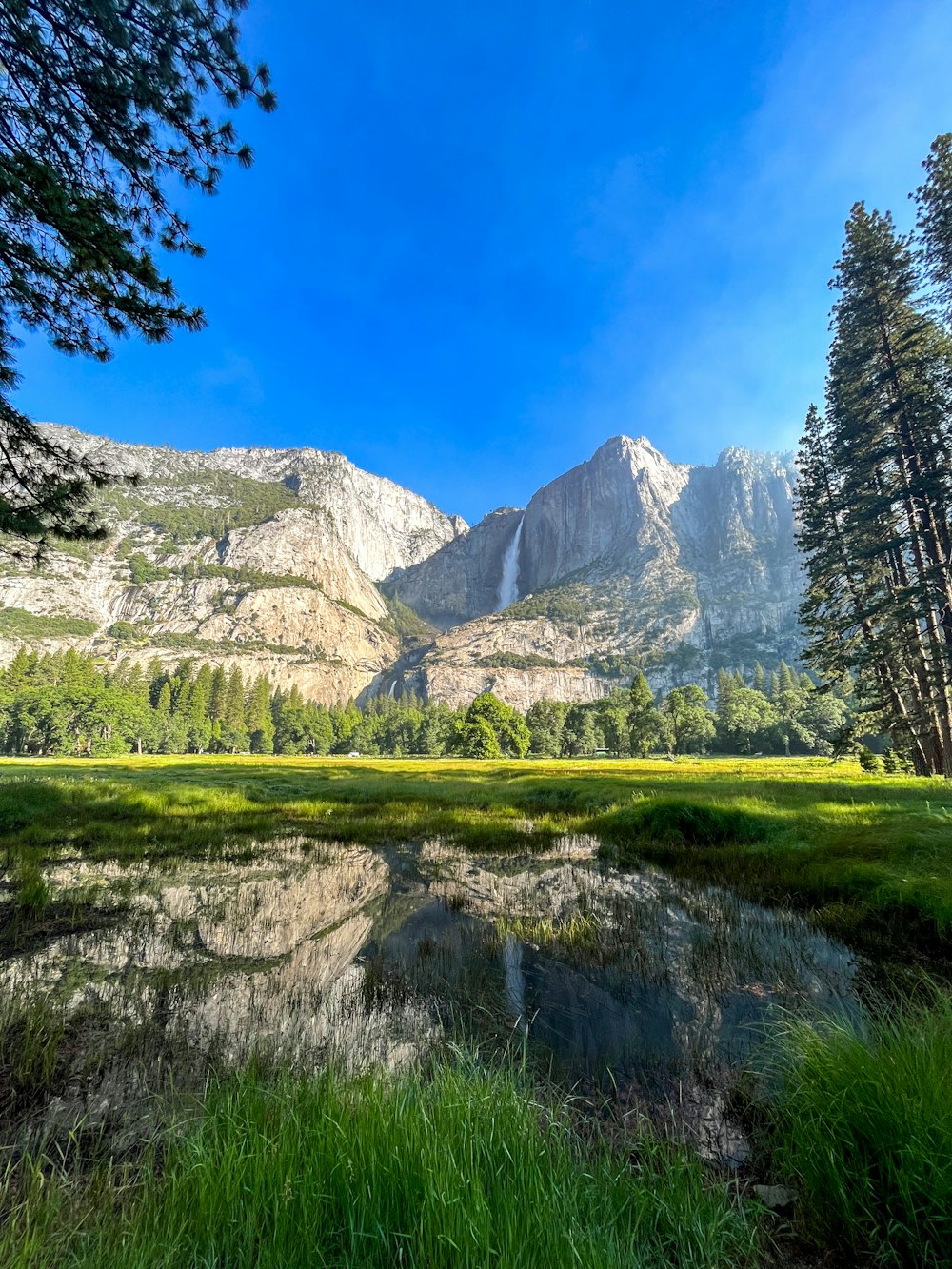 a view of a mountain range with a lake in the foreground