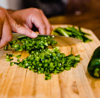 Hands carefully packing fresh produce in a clean, bright kitchen with natural light streaming in.