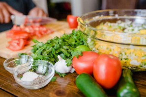 Close-up of fresh ingredients neatly arranged on a wooden kitchen table