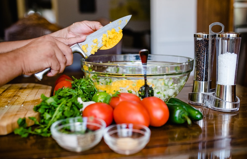 a person using a knife to cut up some food