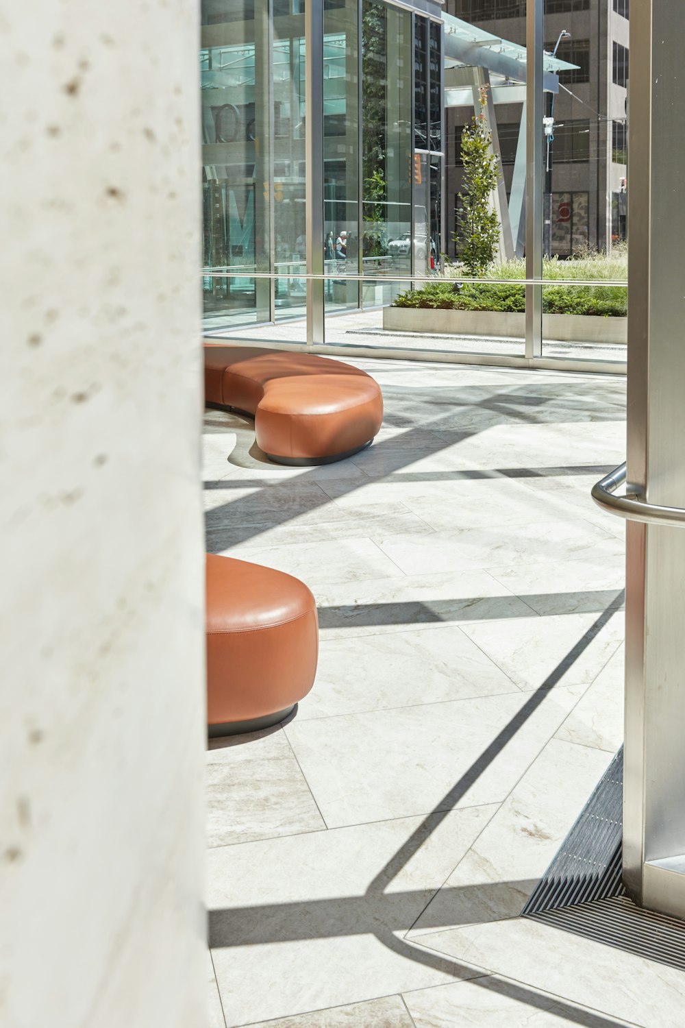 a room with a bunch of benches and a building in the background