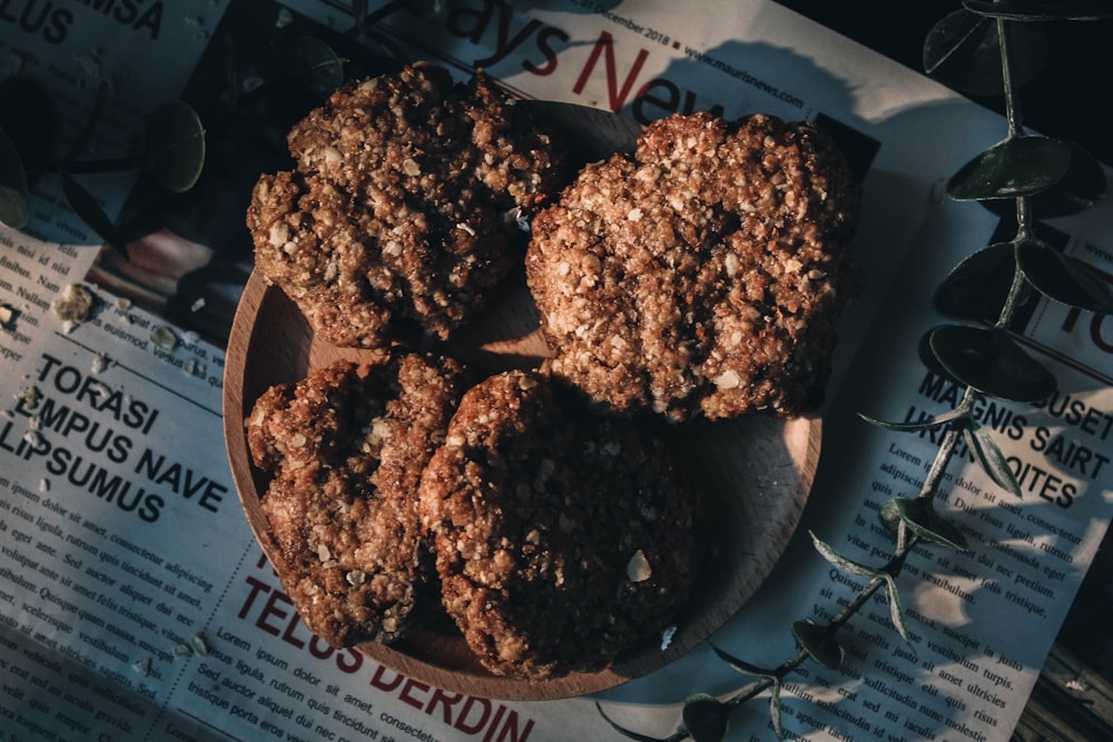 a plate of cookies sitting on top of a newspaper