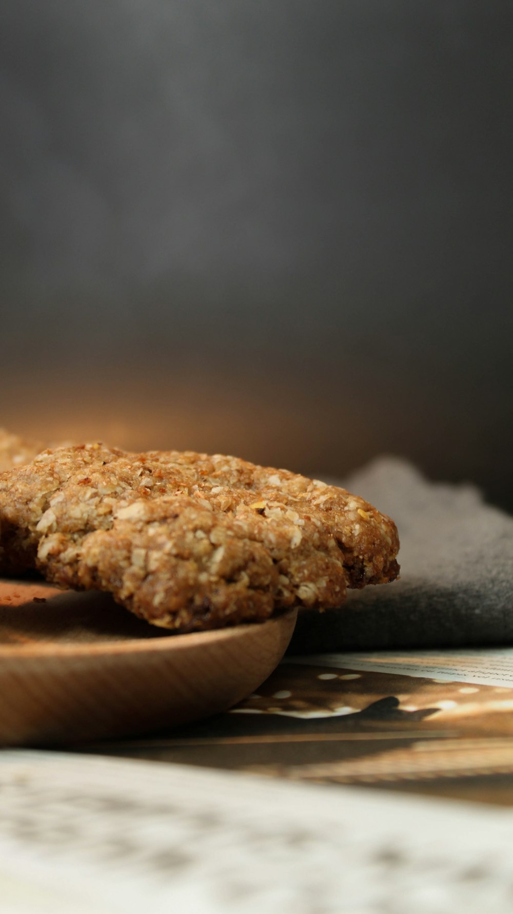 a close up of two cookies on a wooden plate