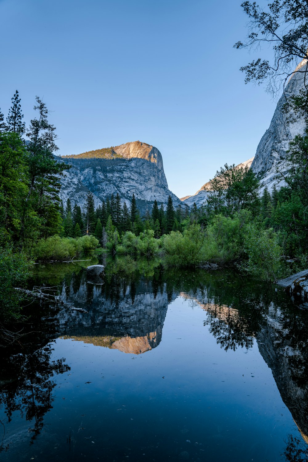 a lake surrounded by mountains and trees