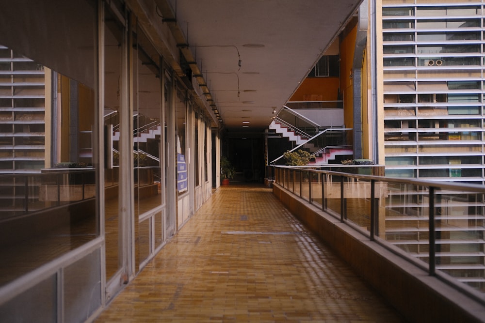 a long hallway with glass doors leading to a building