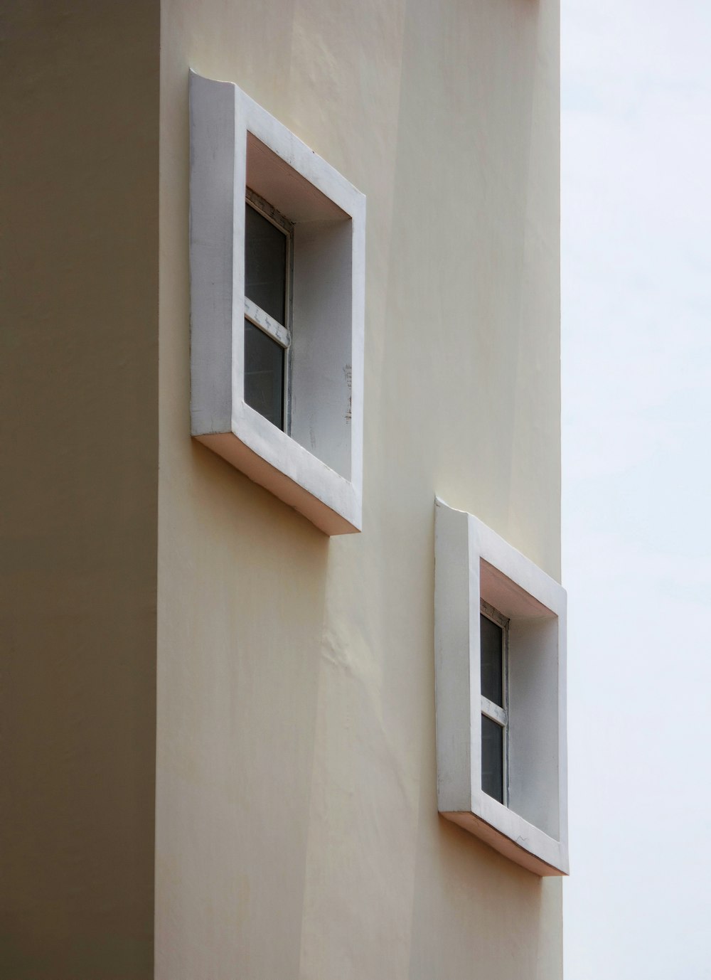 two windows on the side of a building