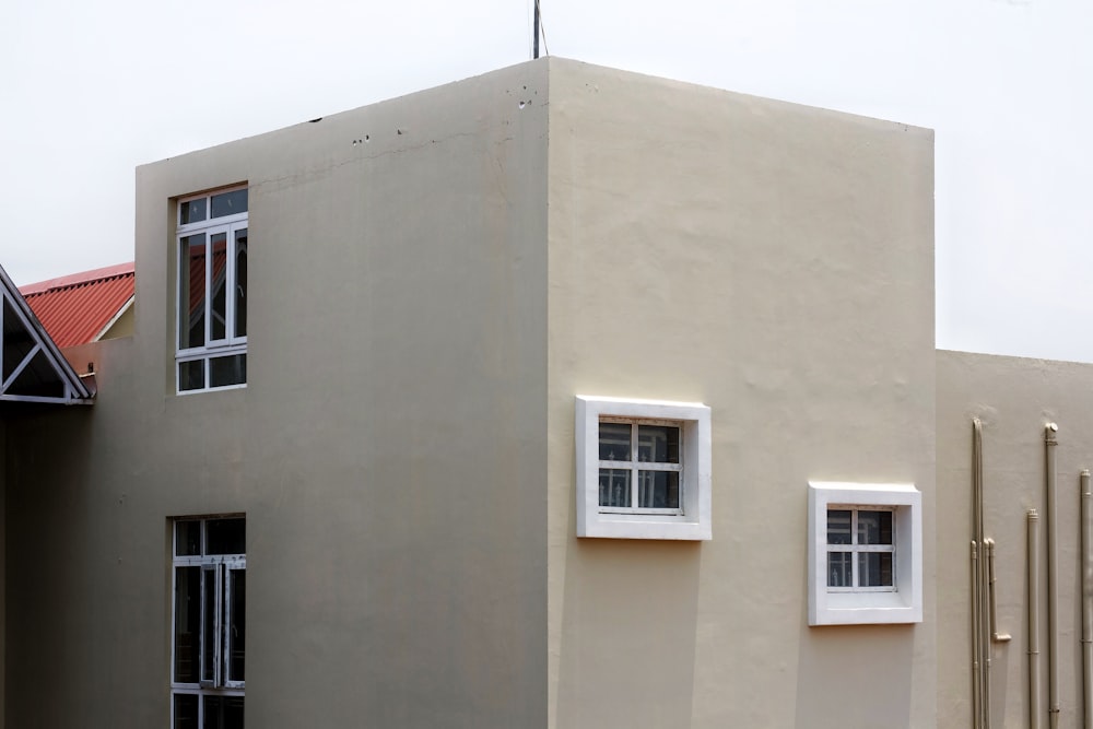 a building with two windows and a red roof