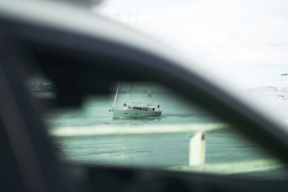 a white boat floating on top of a body of water