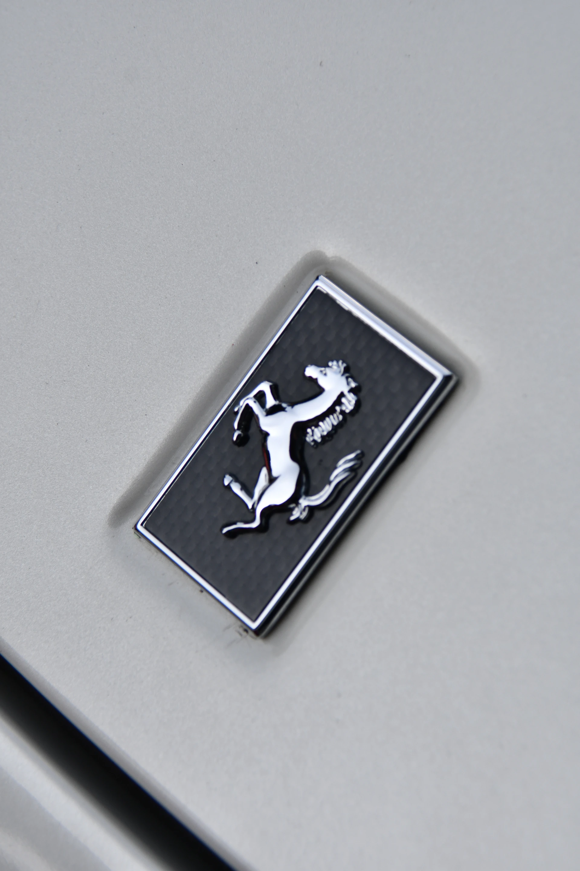 Close-up of a beautifully designed logo featuring an Arabian horse silhouette in gold on a deep black background.