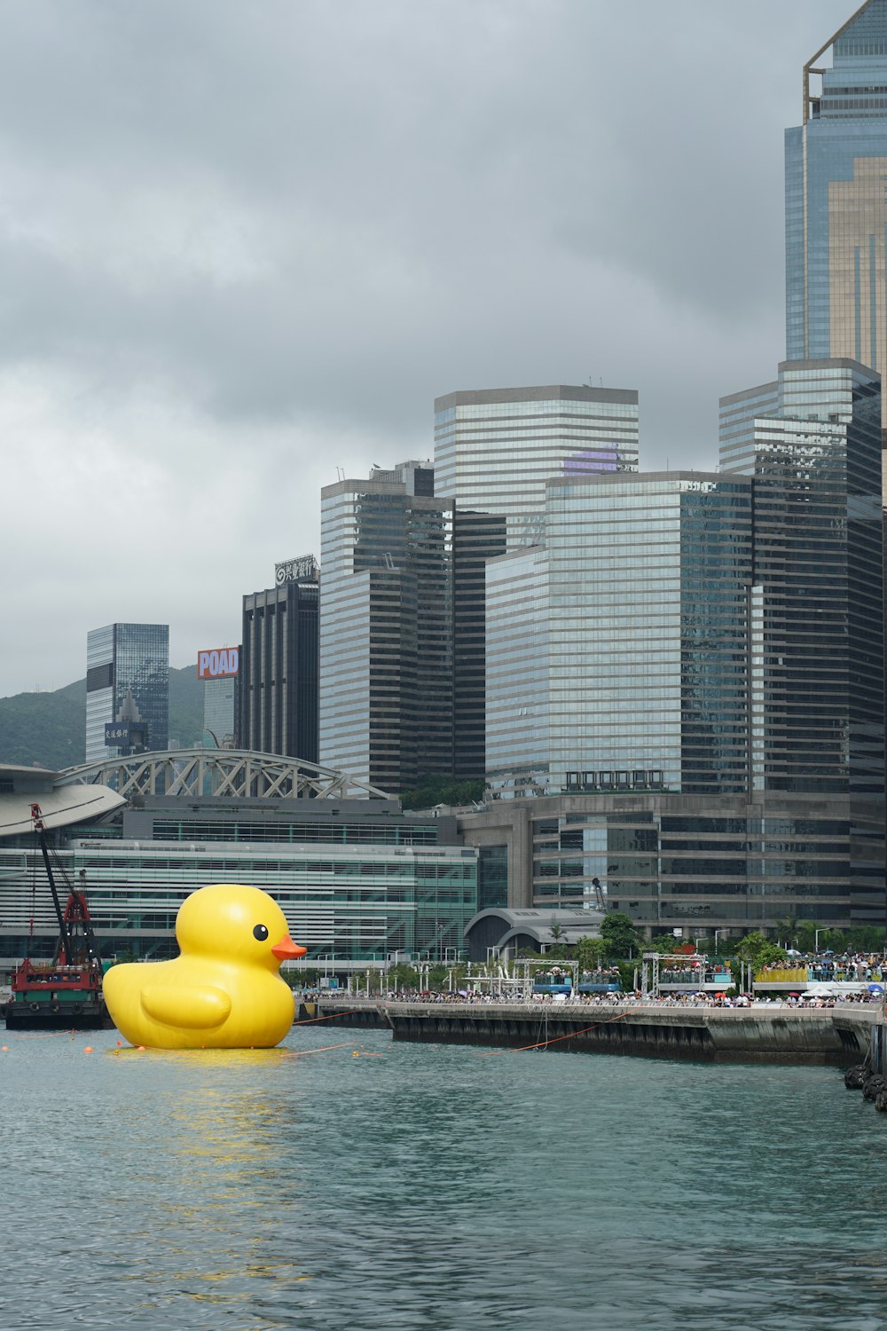 a large yellow rubber duck floating in a body of water