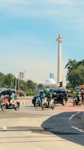 a group of people riding motorcycles down a street