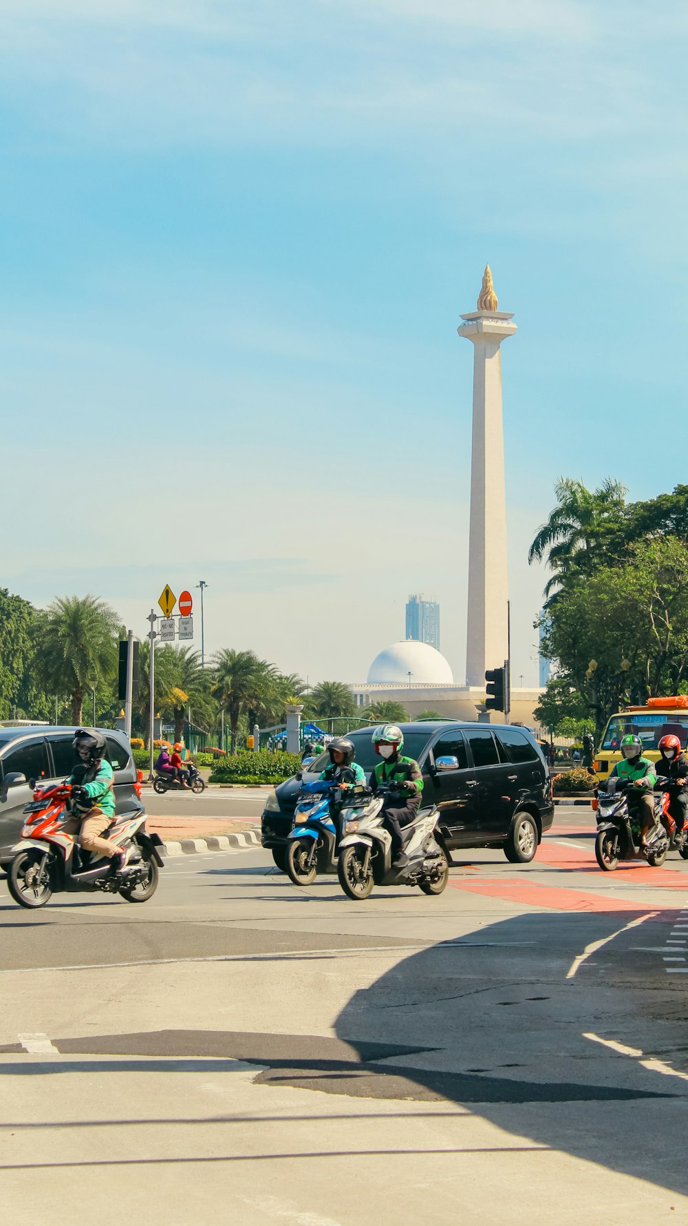 a group of people riding motorcycles down a street