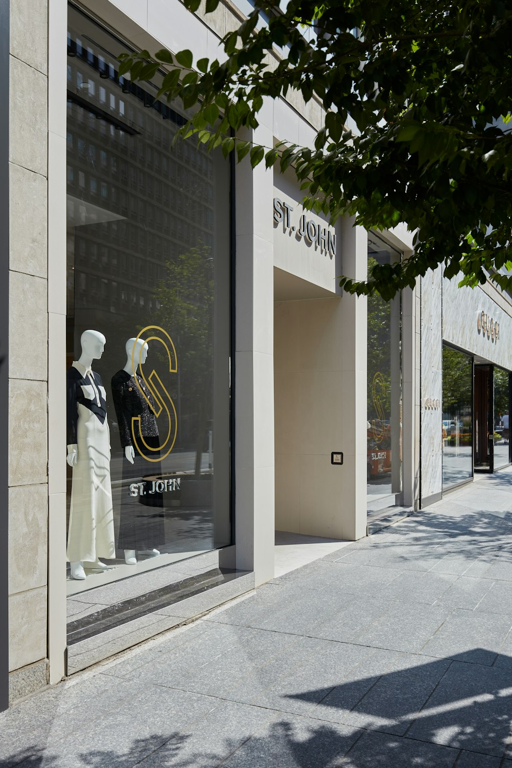 a store front with mannequins in the window