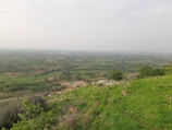 A panoramic view of farmland stretching toward the horizon in East Africa.