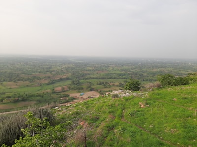 A panoramic view of farmland stretching toward the horizon in East Africa.