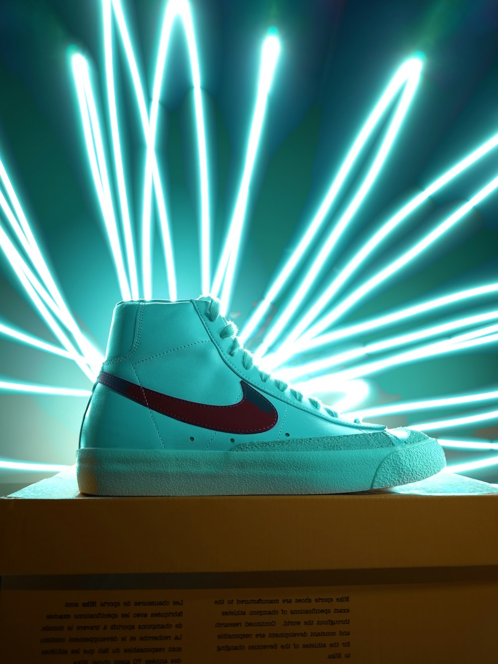 a pair of sneakers with a light show in the background