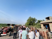 Consultant discussing agricultural plans with local farmers outdoors.