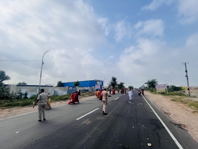 A diverse group of workers in uniforms representing security, hospitality, and factory roles.