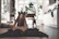 A happy woman doing Pilates at home in a bright, cozy living room.