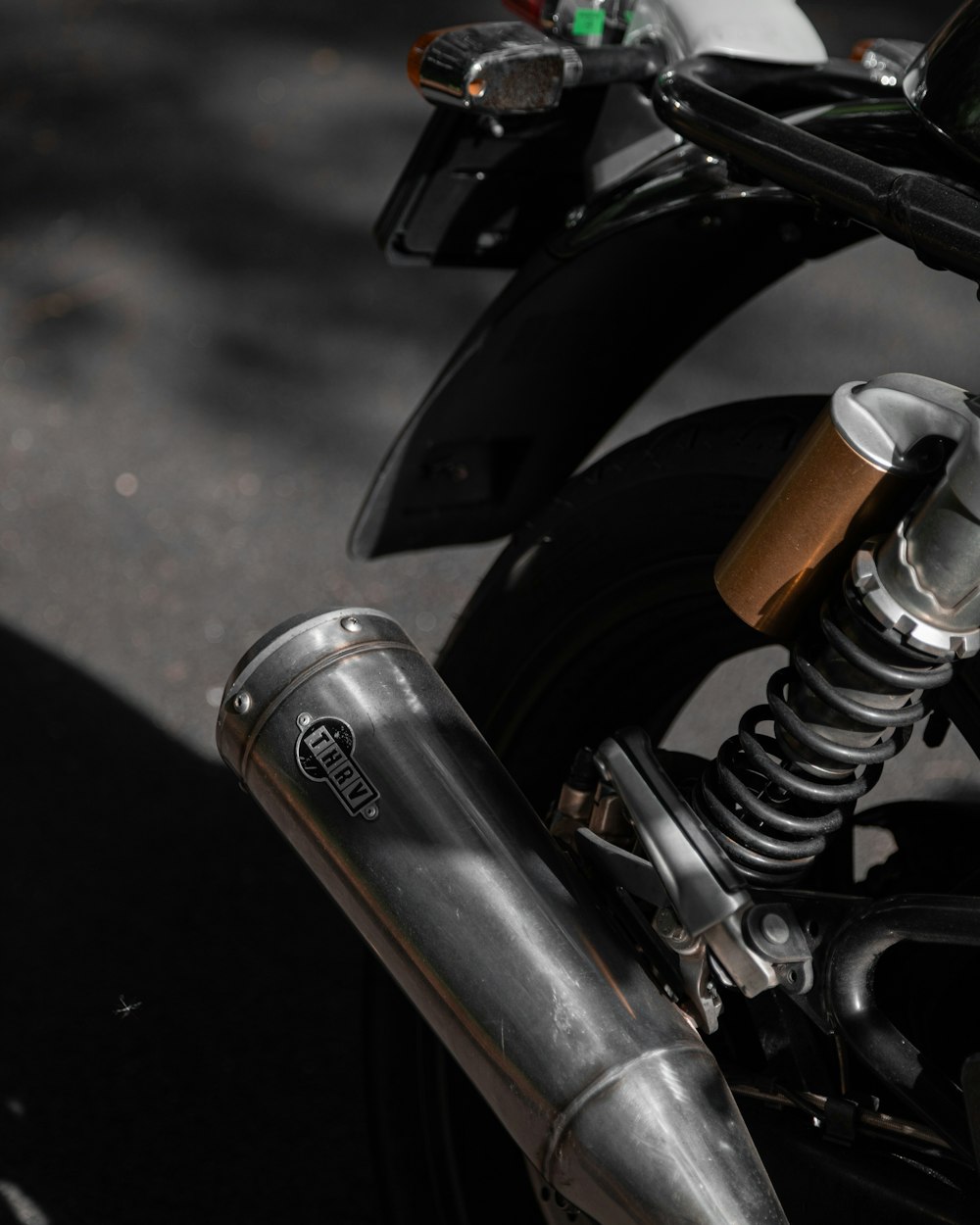 a close up of a motorcycle with a metal handlebar