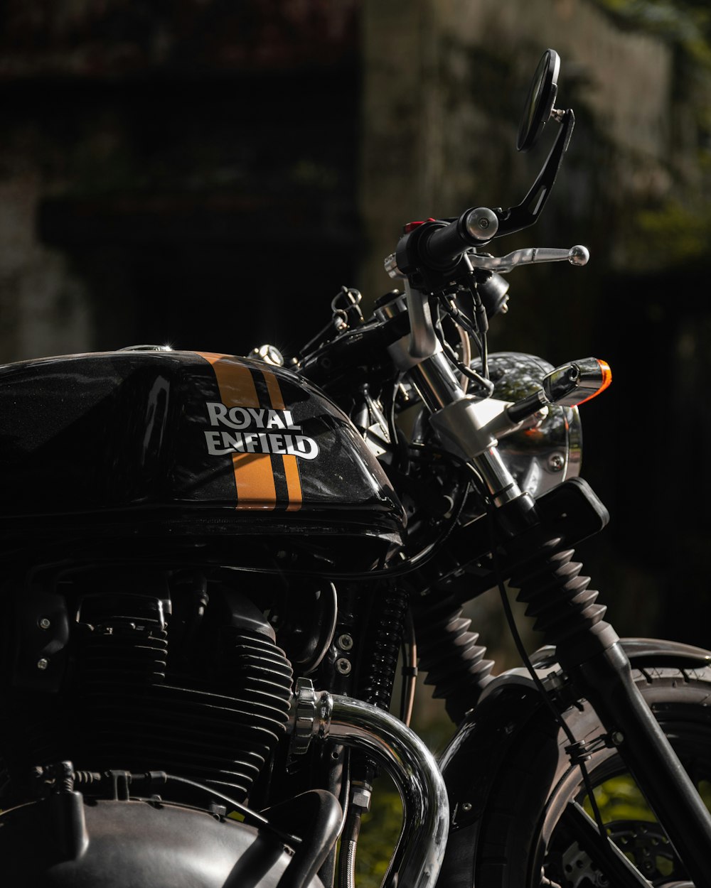 a royal enfield motorcycle parked in front of a building