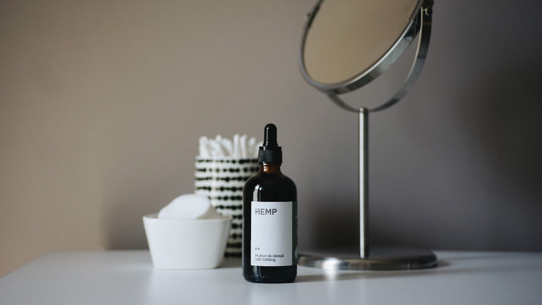 a bottle of cbp sitting on a table next to a mirror,